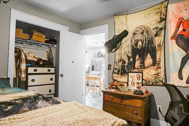 bedroom featuring white fridge with ice dispenser