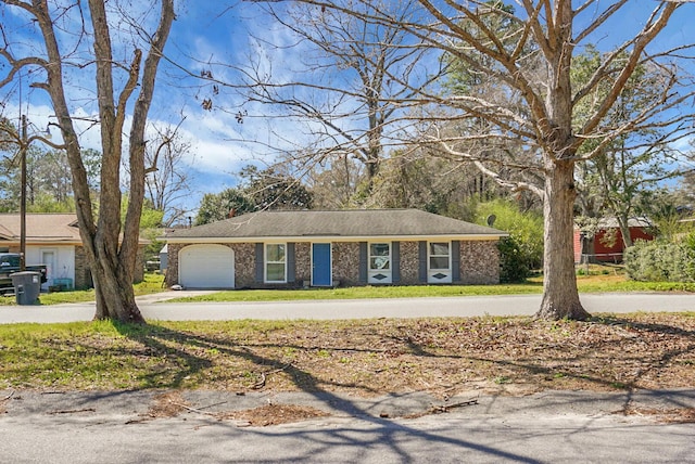 ranch-style house featuring brick siding, an attached garage, and driveway