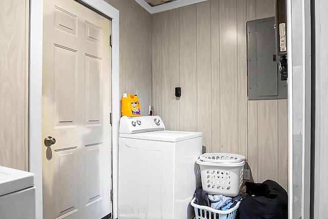 washroom featuring electric panel, washer / dryer, and laundry area