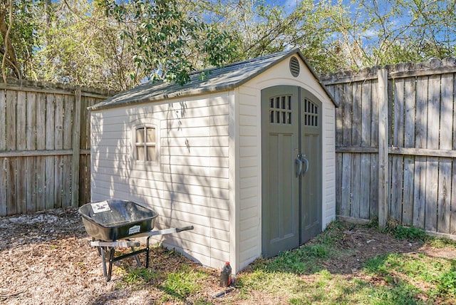 view of shed with a fenced backyard