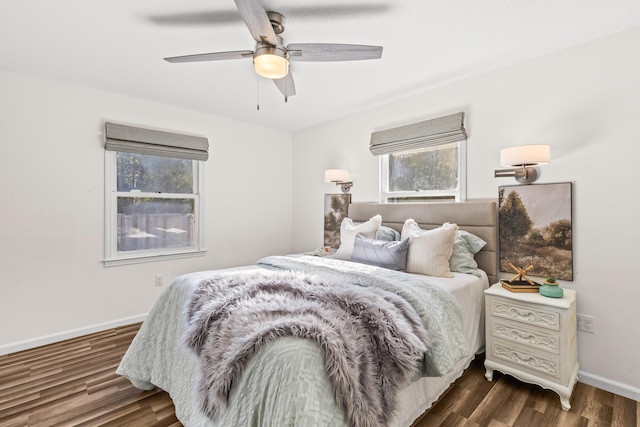 bedroom featuring dark wood finished floors, baseboards, and ceiling fan