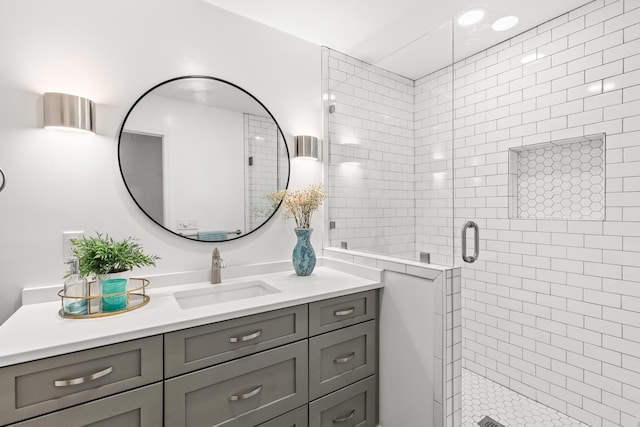 bathroom featuring vanity and a shower stall