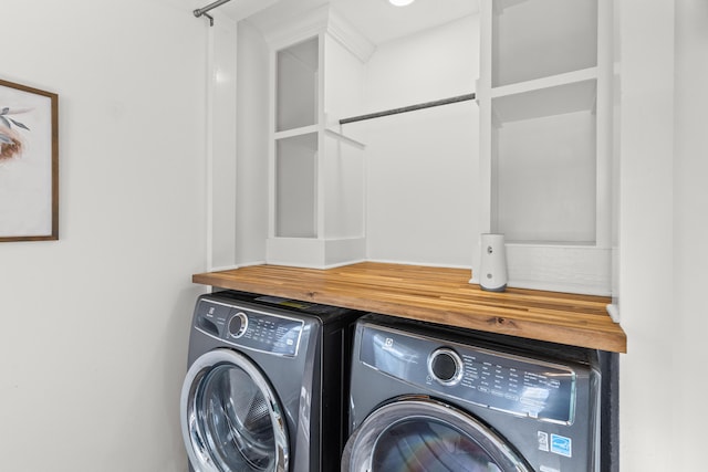 laundry room with laundry area and washing machine and clothes dryer