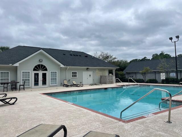 view of pool featuring a patio area and french doors