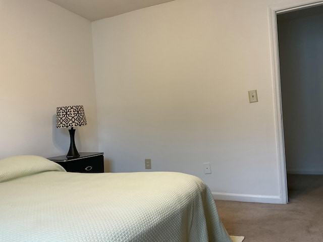 bedroom featuring light carpet