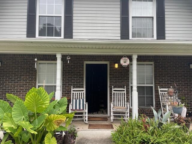 property entrance featuring covered porch