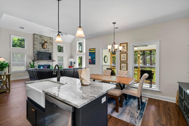 kitchen with a wealth of natural light, visible vents, dishwasher, a sink, and baseboards