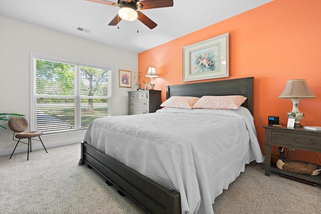 bedroom with carpet flooring, baseboards, a ceiling fan, and visible vents