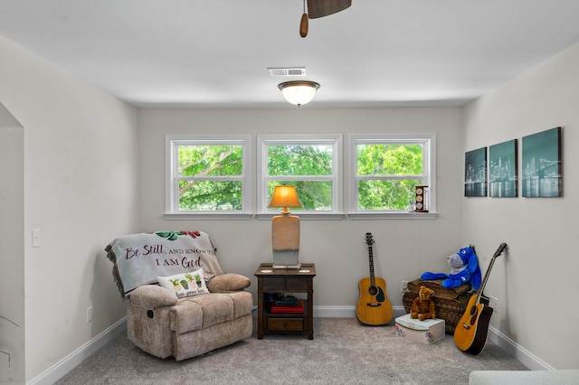 living area with visible vents, baseboards, plenty of natural light, and carpet floors