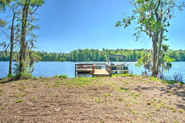 dock area with a water view and a wooded view