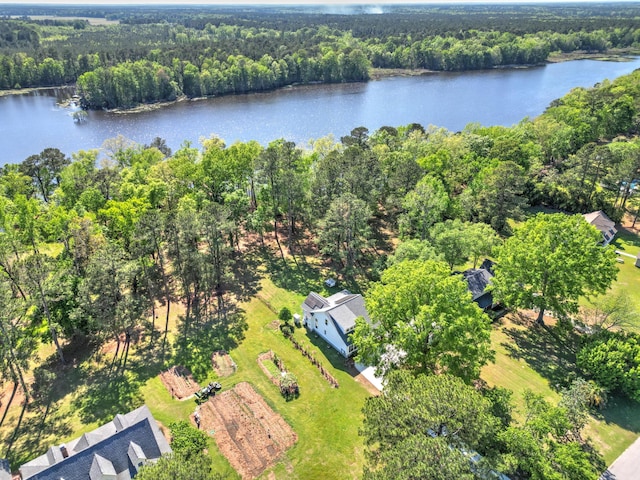 aerial view with a wooded view and a water view