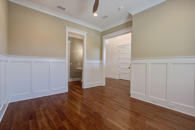 empty room with crown molding, dark wood-type flooring, and ceiling fan