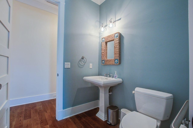 bathroom with toilet and hardwood / wood-style flooring