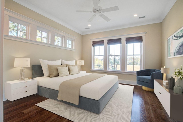 bedroom featuring ceiling fan, crown molding, multiple windows, and dark hardwood / wood-style flooring