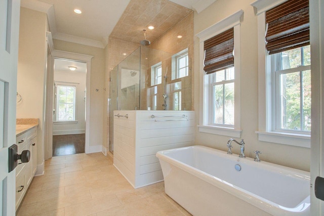 bathroom featuring vanity, hardwood / wood-style flooring, ornamental molding, and shower with separate bathtub