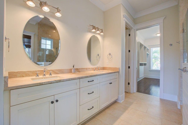 bathroom with vanity, crown molding, and tile patterned flooring