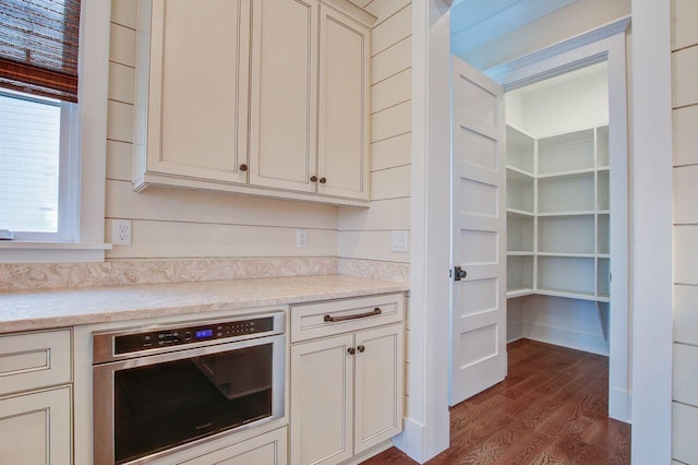 kitchen featuring stainless steel oven and dark hardwood / wood-style flooring