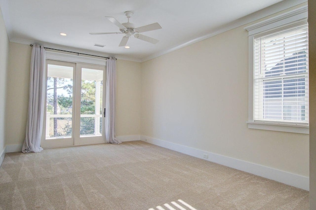 unfurnished room with light carpet, crown molding, and a healthy amount of sunlight