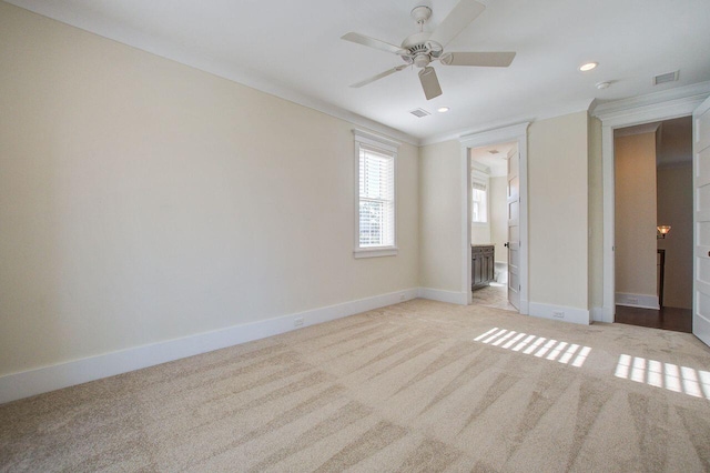 unfurnished bedroom with light carpet, ensuite bathroom, and ceiling fan