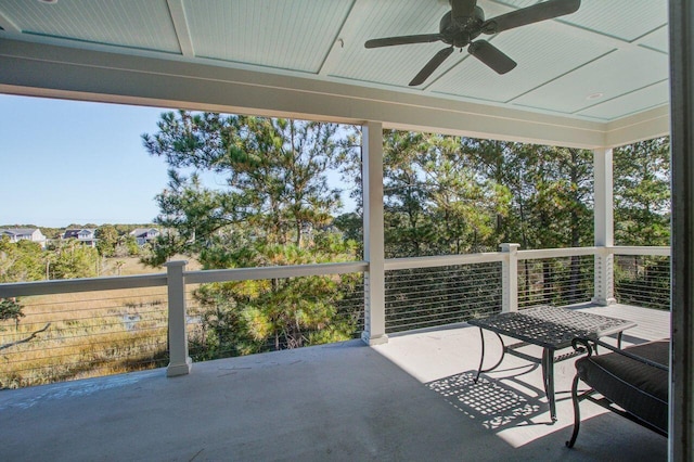 sunroom featuring ceiling fan and a wealth of natural light