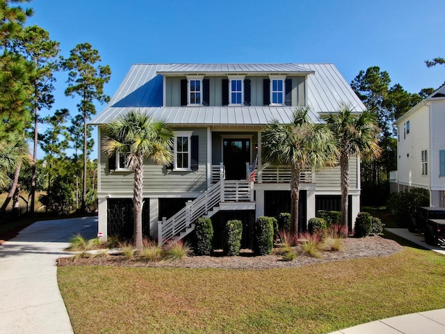 beach home featuring a front yard