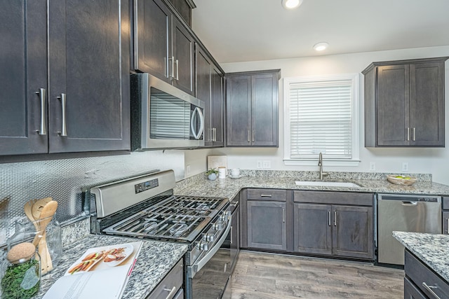 803 Lachicotte Creek Dr, Charleston, SC 29492 - kitchen with appliances with stainless steel finishes, light stone countertops, light wood-type flooring, a sink, and recessed lighting