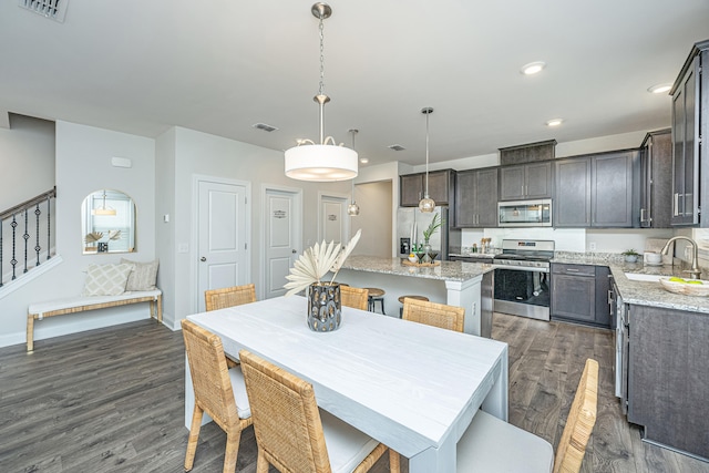 dining space featuring sink and dark hardwood / wood-style flooring