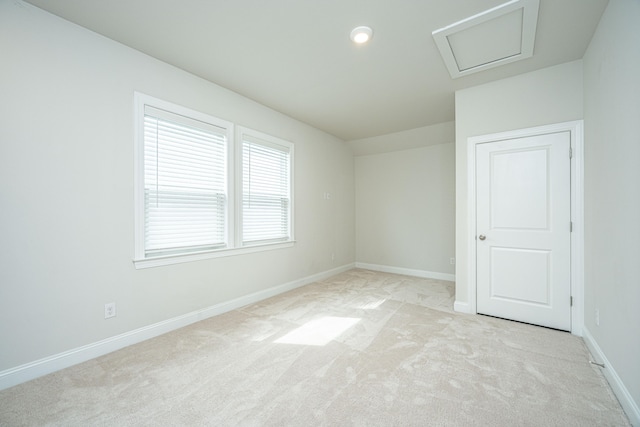 spare room with light colored carpet