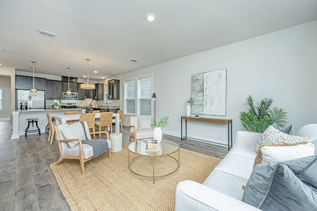 living room with dark hardwood / wood-style flooring