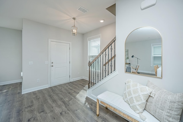 foyer entrance featuring hardwood / wood-style flooring and a chandelier