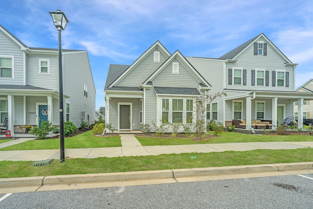 view of front of house with a porch and a front lawn