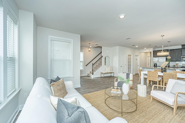 living room with plenty of natural light and dark hardwood / wood-style flooring