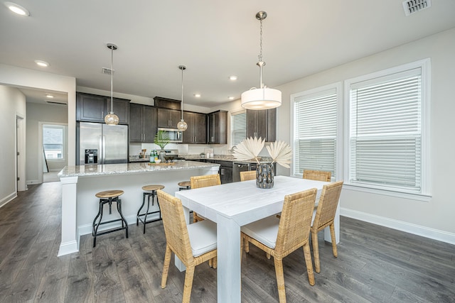 dining space featuring dark wood-type flooring