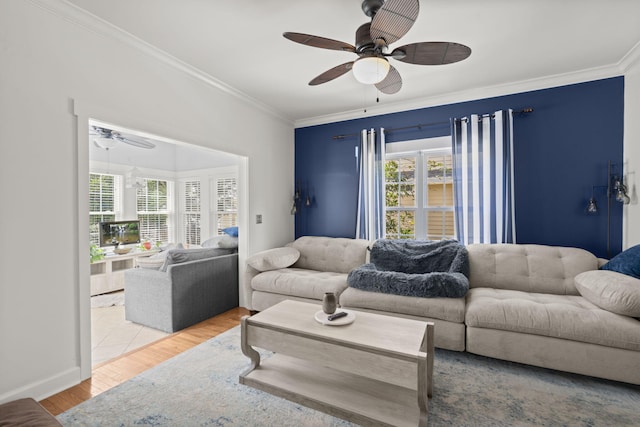 living room with crown molding, a ceiling fan, and wood finished floors