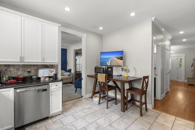 kitchen featuring backsplash, crown molding, appliances with stainless steel finishes, dark countertops, and recessed lighting