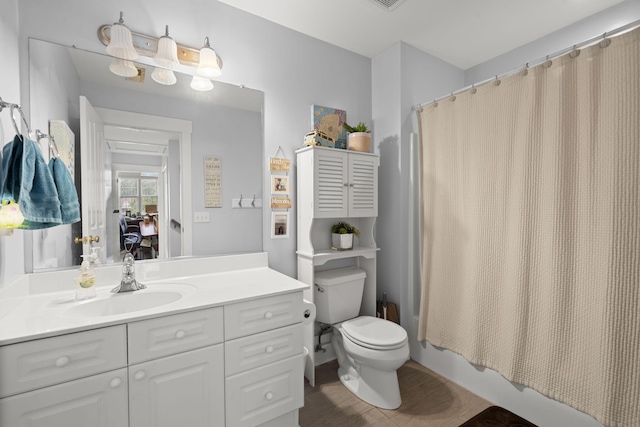 full bath featuring vanity, shower / bathtub combination with curtain, and toilet
