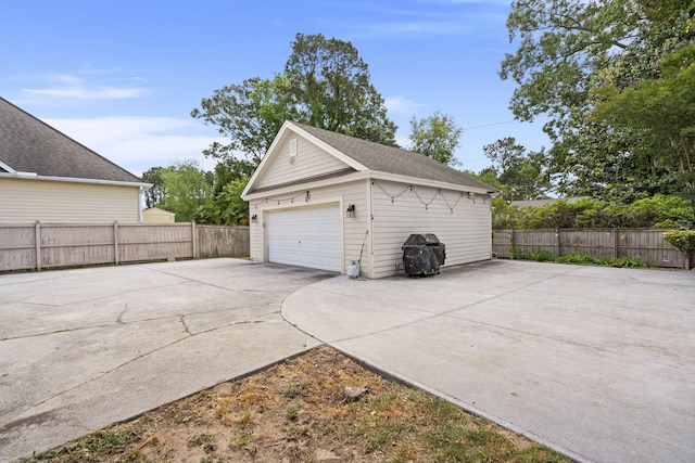detached garage featuring fence