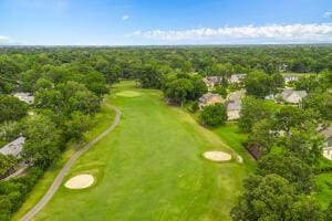 drone / aerial view featuring a view of trees and golf course view