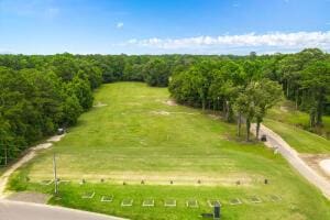 birds eye view of property featuring a forest view