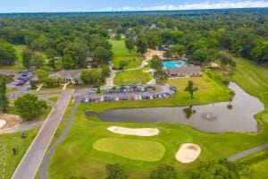 aerial view featuring a water view and golf course view