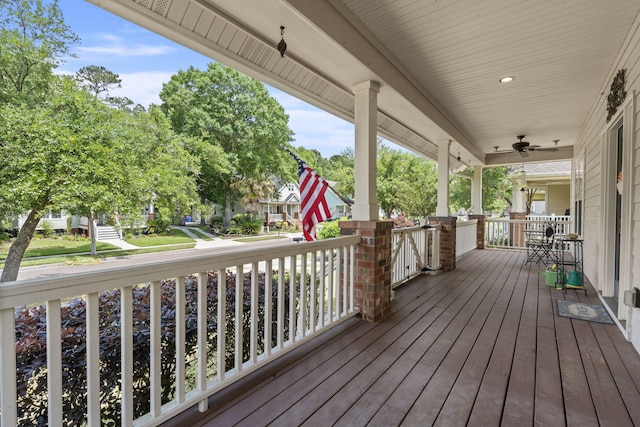 wooden terrace with covered porch and ceiling fan