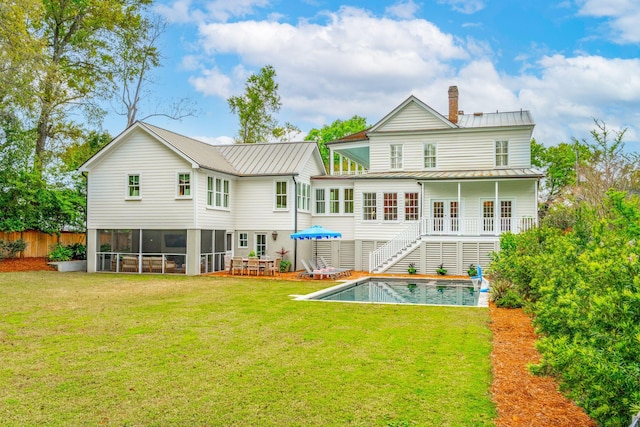 rear view of property with a lawn