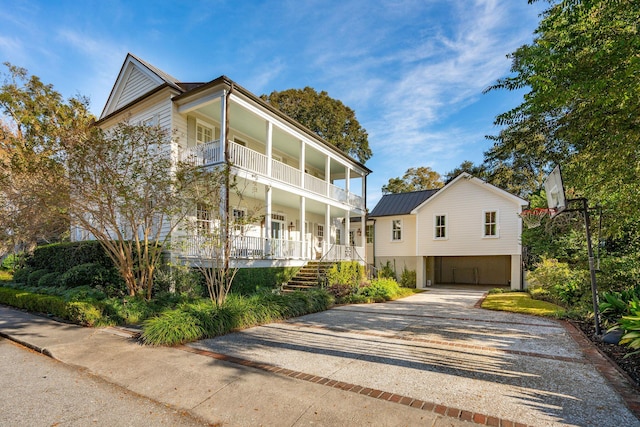 view of front of property with a carport, a porch, and a balcony