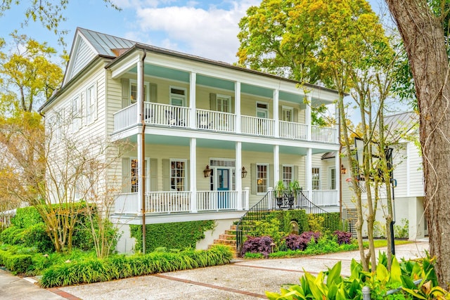 view of front of house featuring covered porch and a balcony