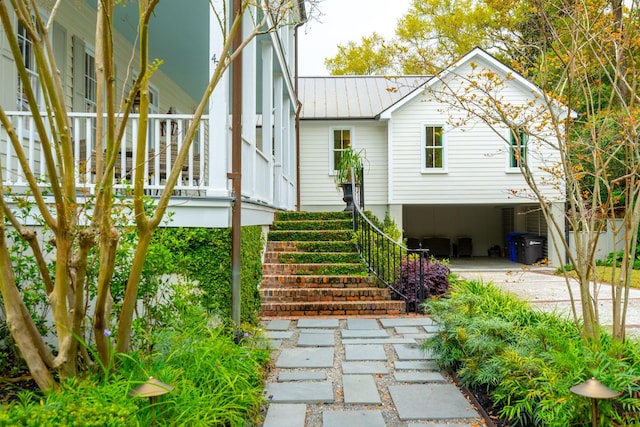 view of side of home featuring covered porch