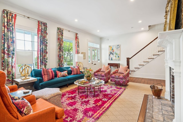 living room with hardwood / wood-style flooring, plenty of natural light, and ornamental molding