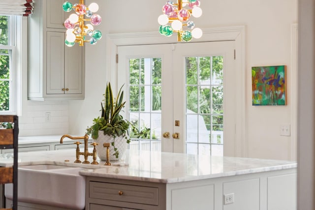 interior space with a healthy amount of sunlight, sink, and a chandelier