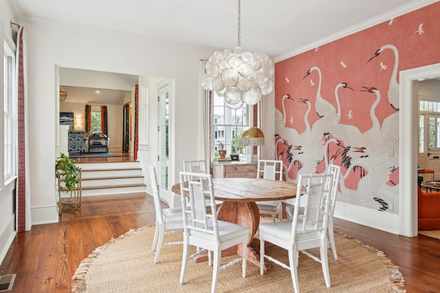 dining space featuring a notable chandelier, dark hardwood / wood-style floors, and crown molding