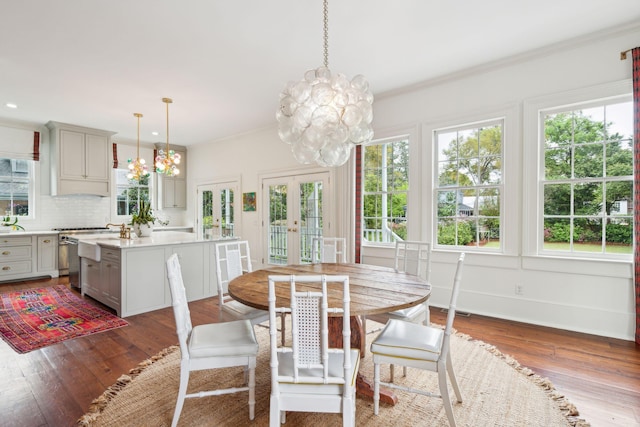 dining area with dark wood-type flooring, french doors, a healthy amount of sunlight, and ornamental molding