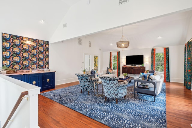 living room with hardwood / wood-style floors and lofted ceiling